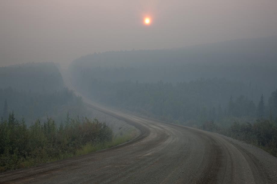 The sun is barely visible through forest fire smoke along the James Dalton Highway.