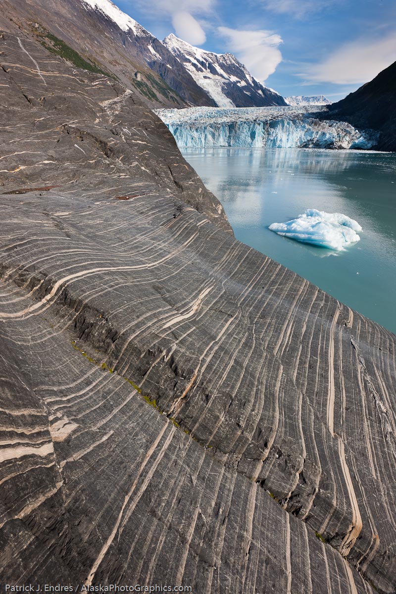Layered sediments revealed in rock ground smooth by glacier weight and travel. Tidewater face of Cascade glacier and icebergs floating in Barry Arm, Chugach National Forest, Prince William Sound, southcentral, Alaska. Canon 1Ds Mark III, 16-35mm 2.8L (@16mm),  1/50 sec @ f/16, ISO, handheld.