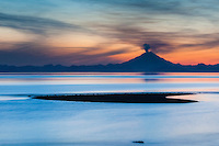 Plume of gas and vapor vent from the summit of Mt. Redoubt volcano (10,191 ft), of the Chigmit mountains, Aleutian range. View across Cook Inlet approximately 50 miles, at sunset, southcentral, Alaska.