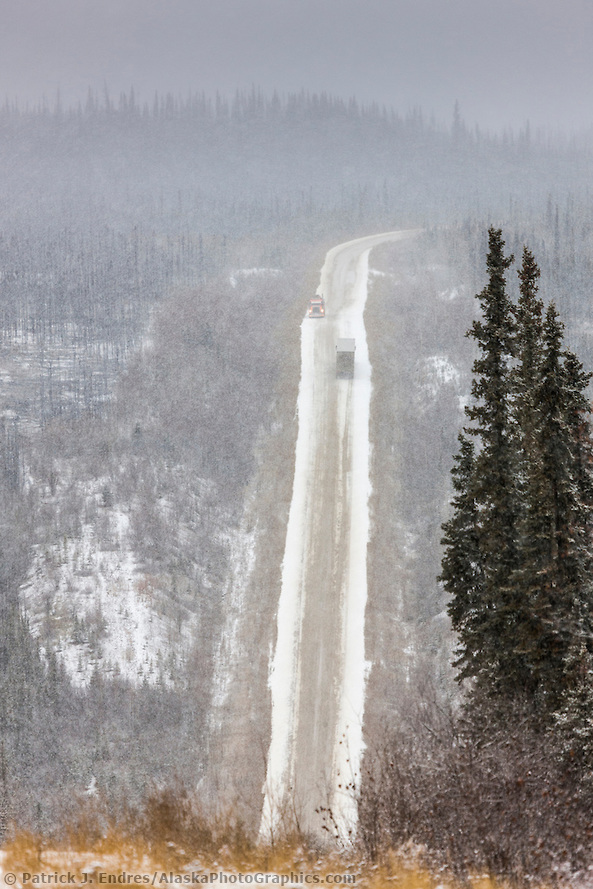 Semi tractor trucks travel the perilous section of road on the Dalton Highway, or haul road, known as the Rollercoaster, a very steep decending hill. (Patrick J. Endres / AlaskaPhotoGraphics.com)