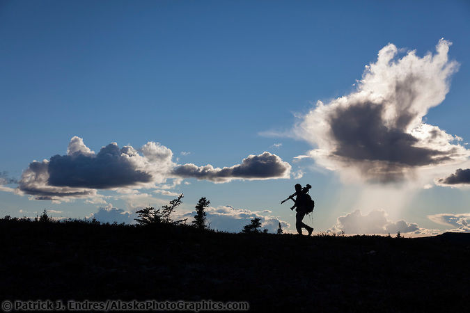 Photographer silhouetted against the sky in Denali National Park. (Patrick J. Endres / AlaskaPhotoGraphics.com)