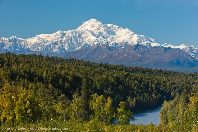 View of the south summit of Mt McKinley, locally called "Denali", North America's tallest mountain, 20,320 ft. Chulitna river in the foreground.