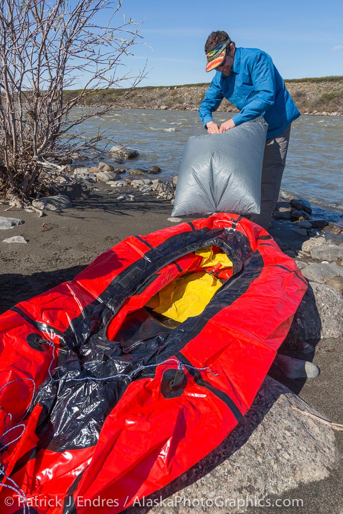Mark blowing up his packraft for the first crossing at the start - the Sagavanirktok river.