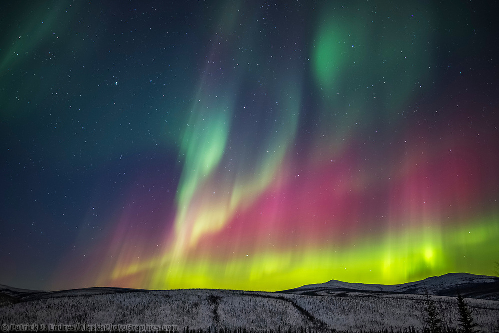 The colorful aurora arcs over the White Mountains National Recreation Area, Interior, Alaska. (Patrick J Endres / AlaskaPhotoGraphics.com)